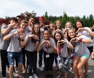 New students making heart signs