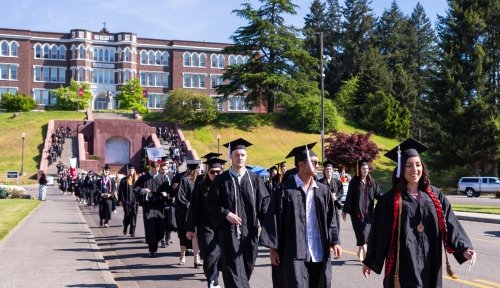 Graduates walking from Old Main Staircase